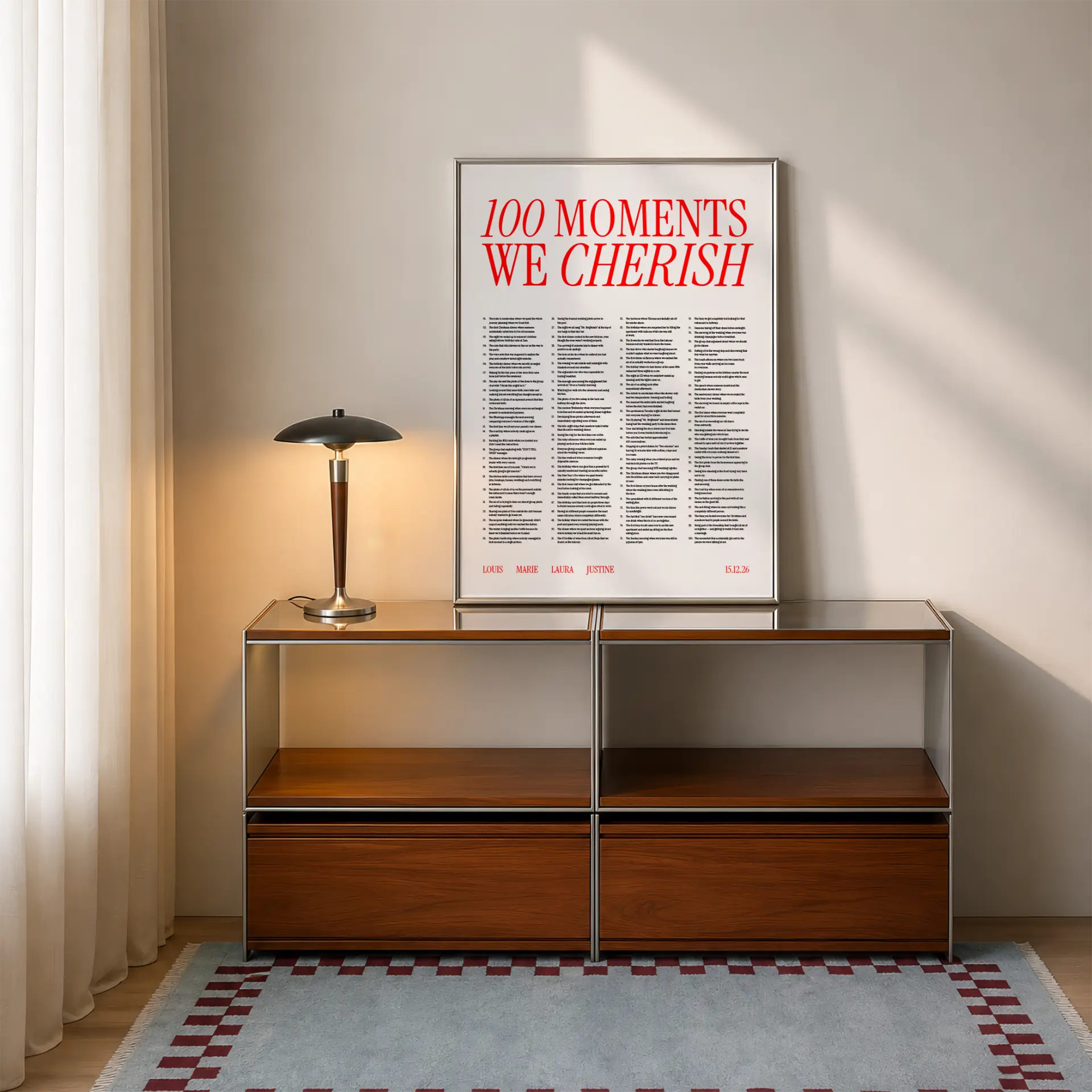 100 moments poster in red title, framed in a modern interior
